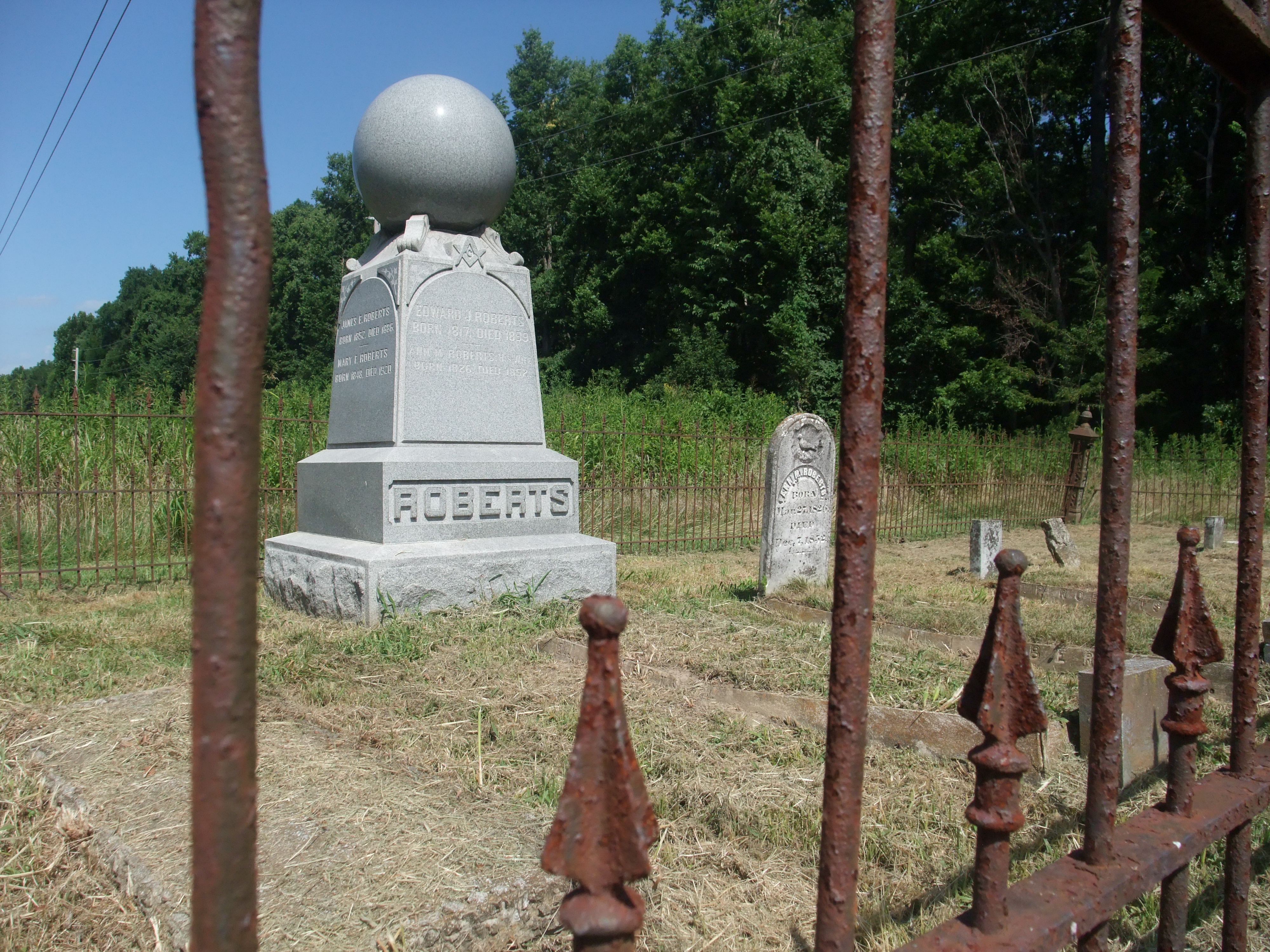 a marble grave behind a gate