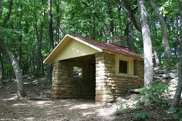 small rock building with roof and open on one side