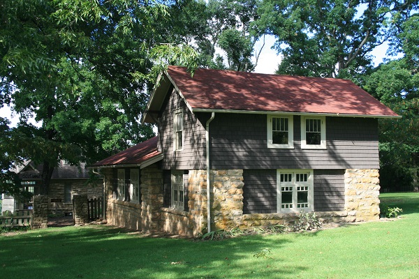 the historic garage is a small two-story rock and siding building