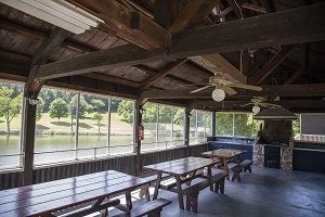 picnic tables and fire place inside the boat house shelter