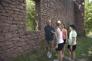 Family of four looking at the rock engine house ruins
