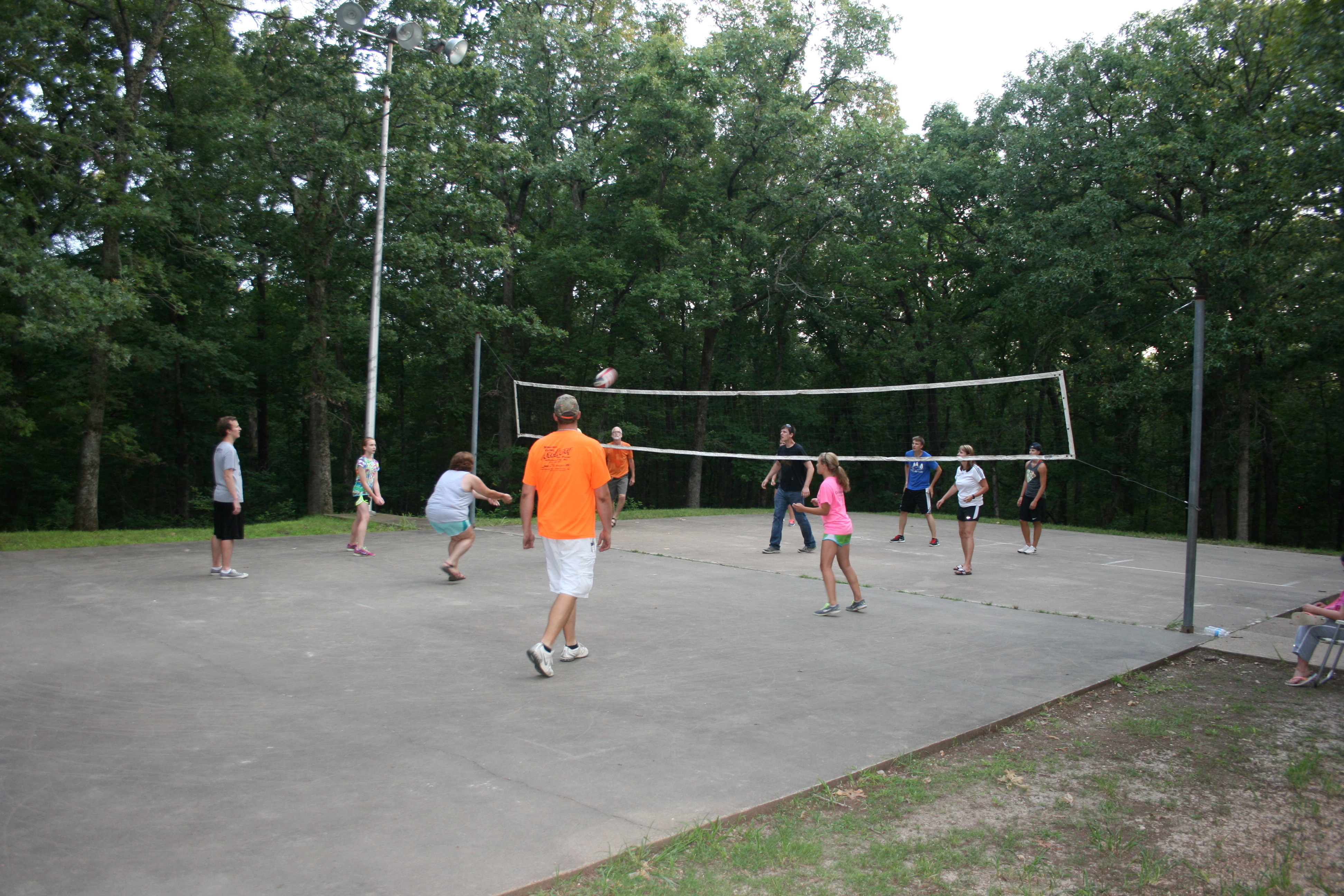 people playing volleyball on the play court
