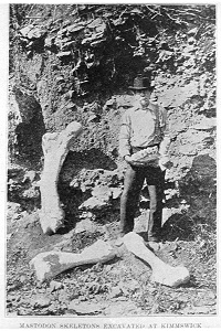 man standing with bones found at the site