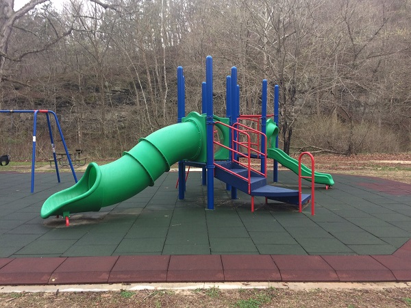 slides on cushioned playground area