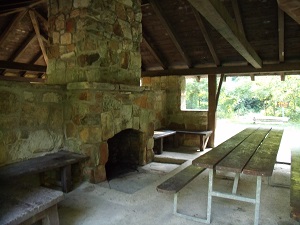 rock fireplace and table inside a shelter