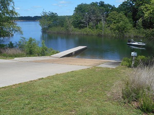 paved boat ramp and wooden dock 