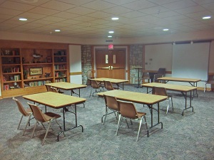 several small tables and chairs inside one of the meeting rooms