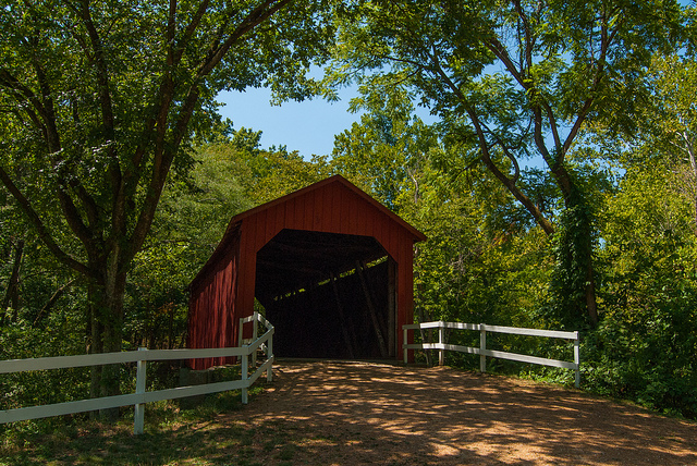 the entrance to the red covered bridge
