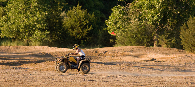 a four-wheeler riding across the sand flats