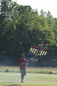 a man controlling a radio-controlled air plane