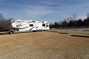 an open parking area with one camper