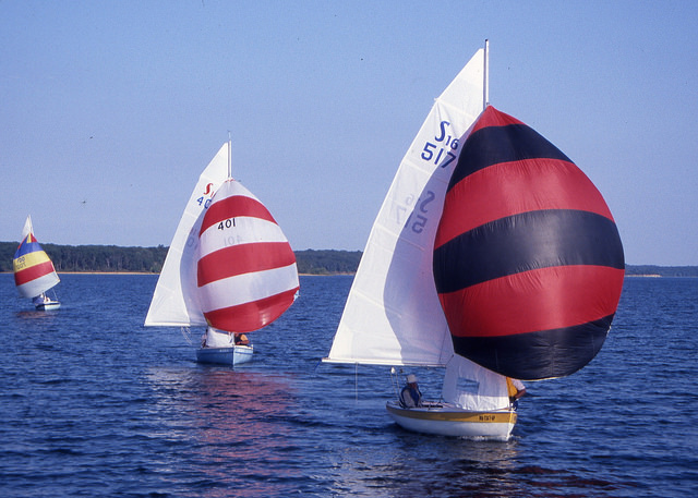 three sailboats on the lake