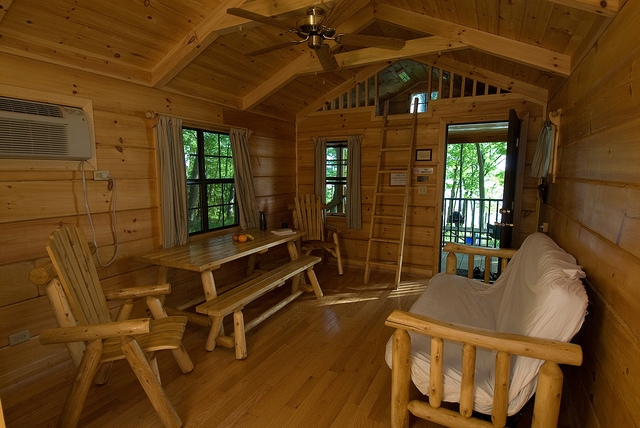 Interior of a camper cabin with futon and table