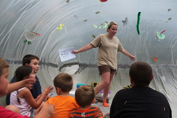 an interpreter and some kids inside an interpretive bubble
