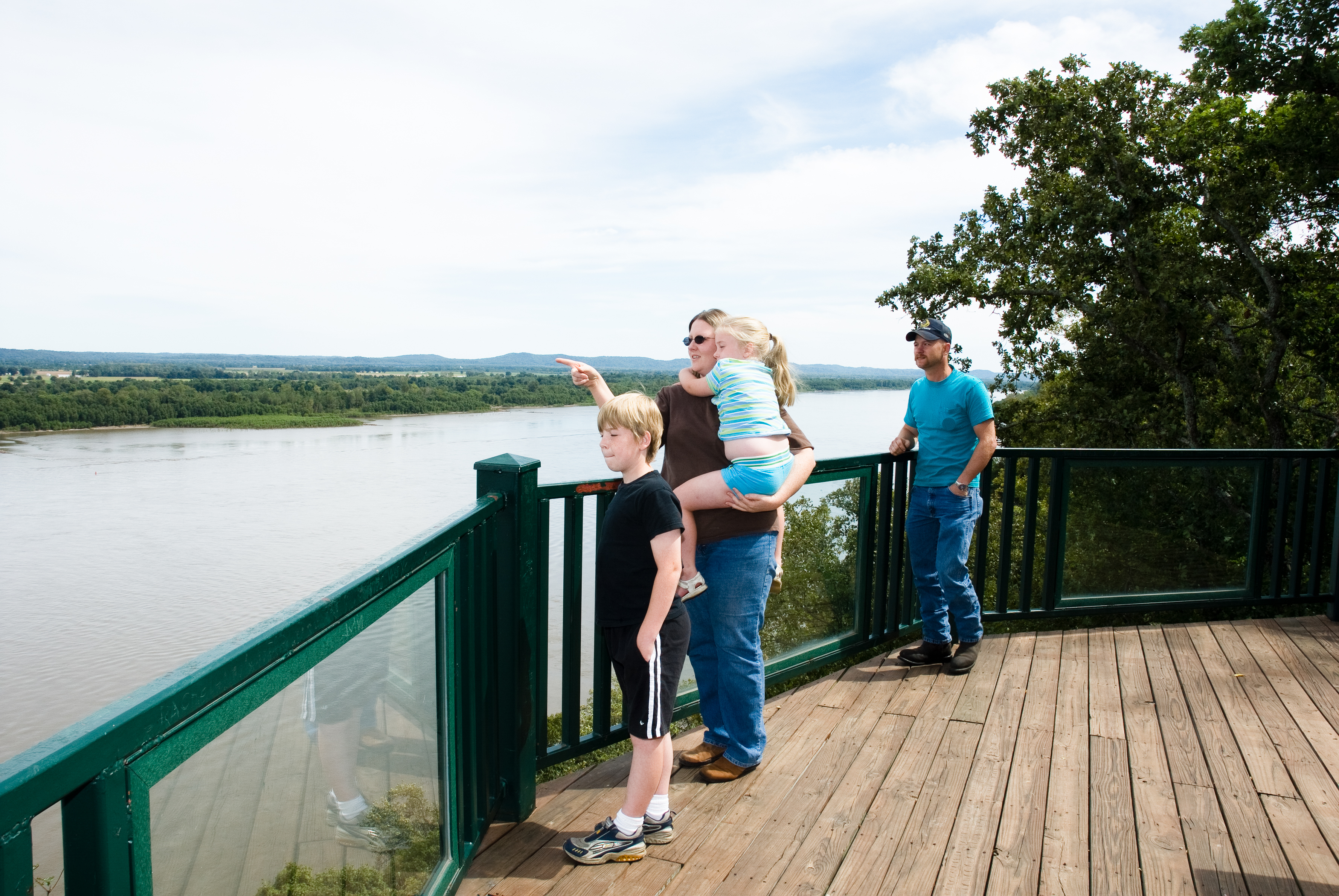 People standing on a balcony overlooking the water