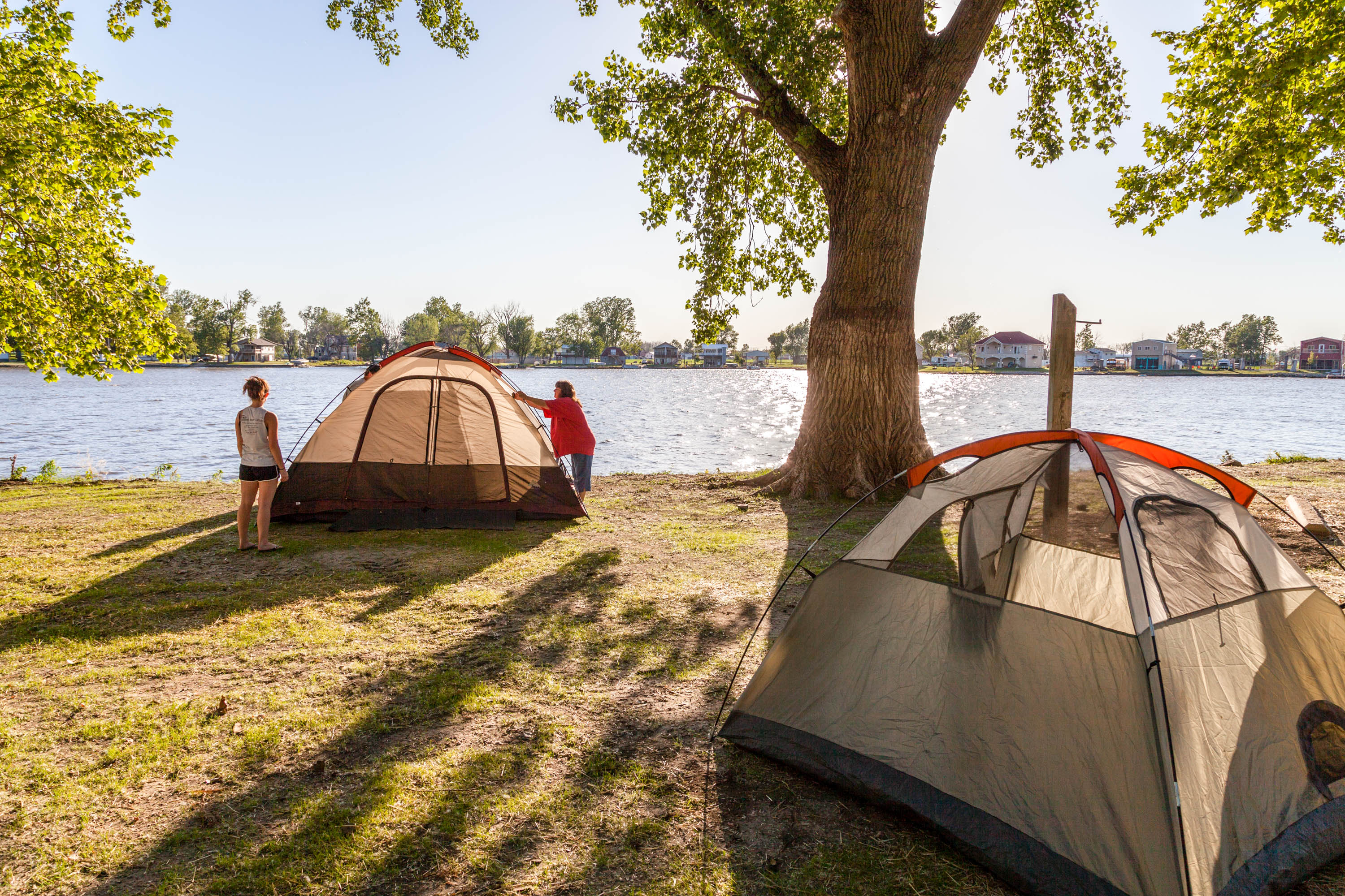 people setting up tents by the lake at Big Lake State Park