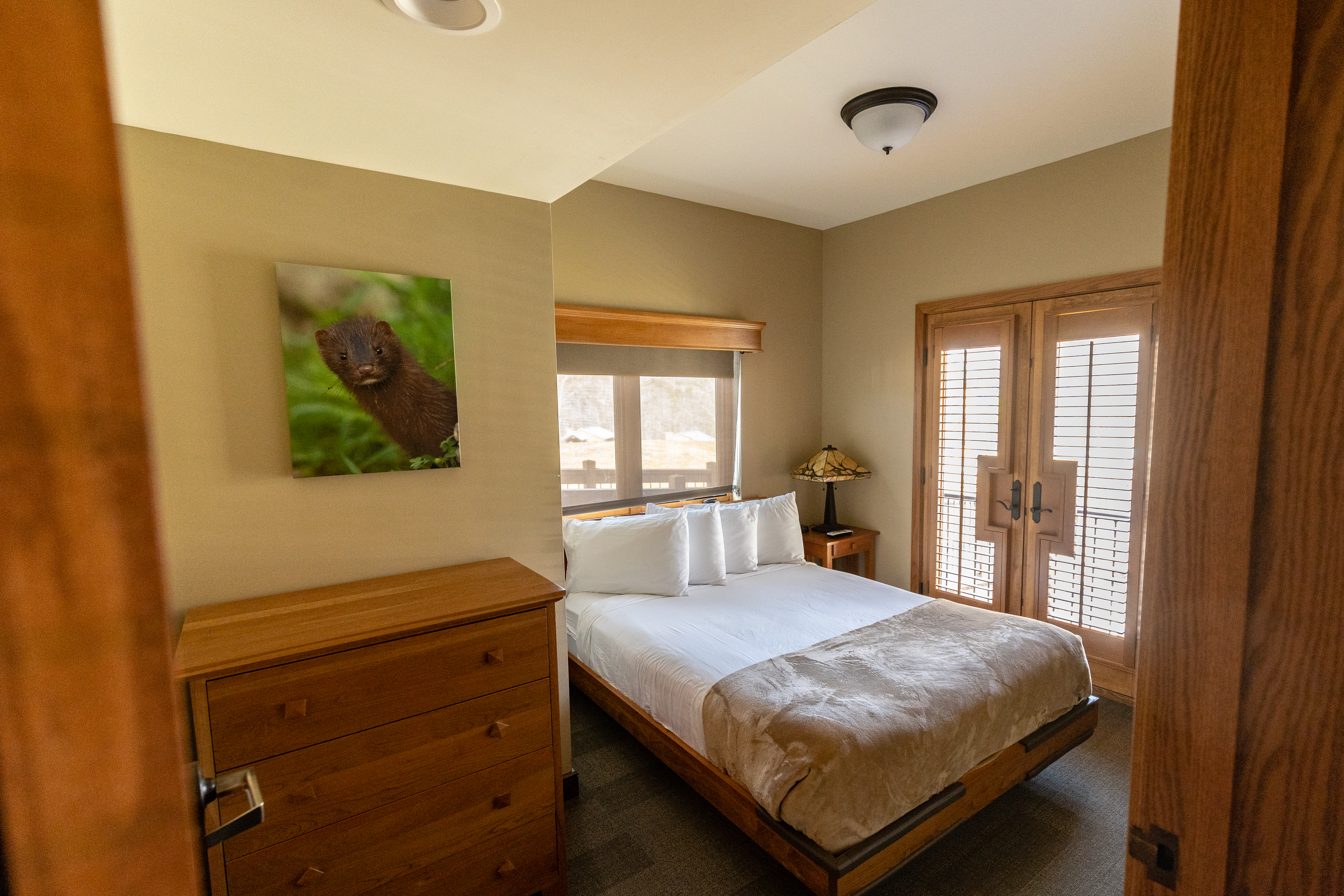 a room with a bed and dresser