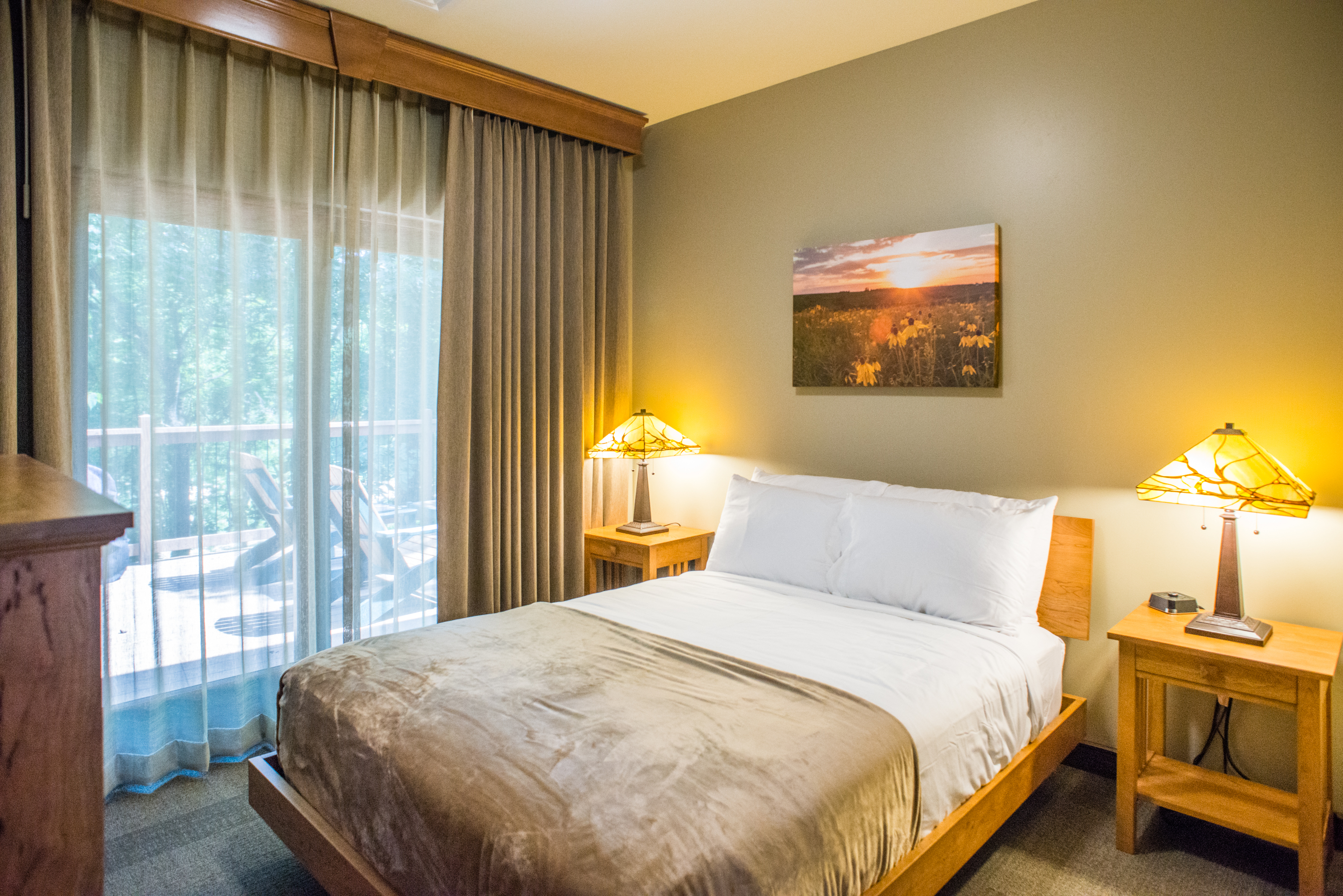 a bedroom with a full sized bed and a large window