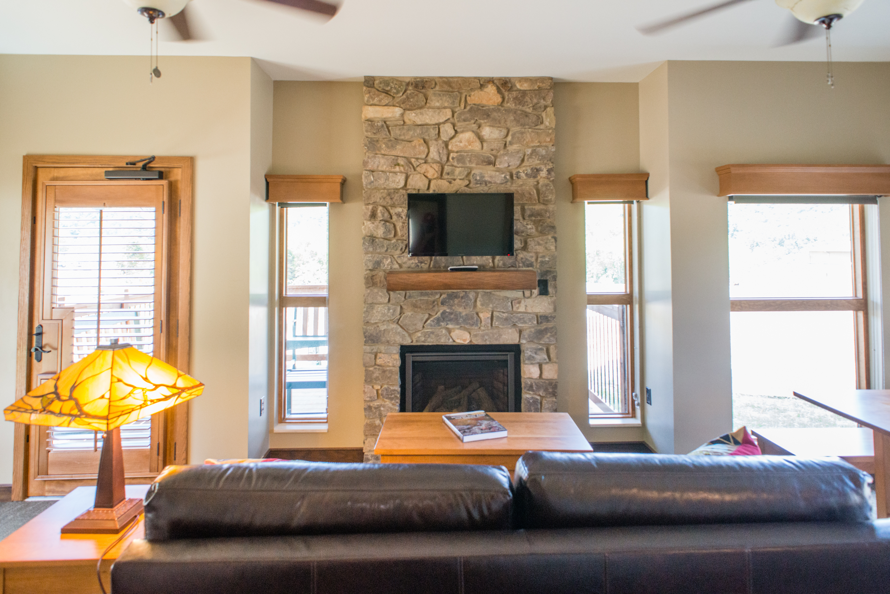 a lounge area with a sofa, fireplace, and TV