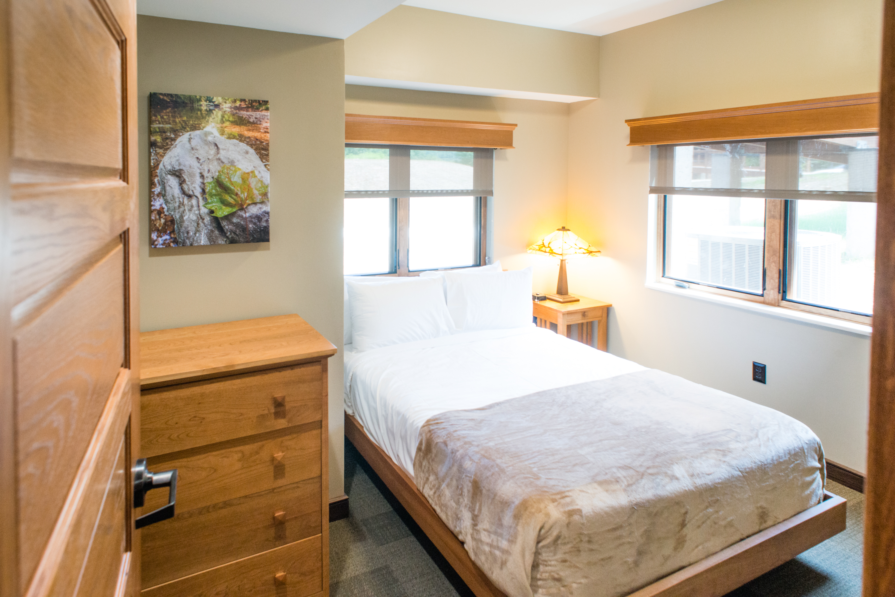 a room with a twin-sized bed and a dresser