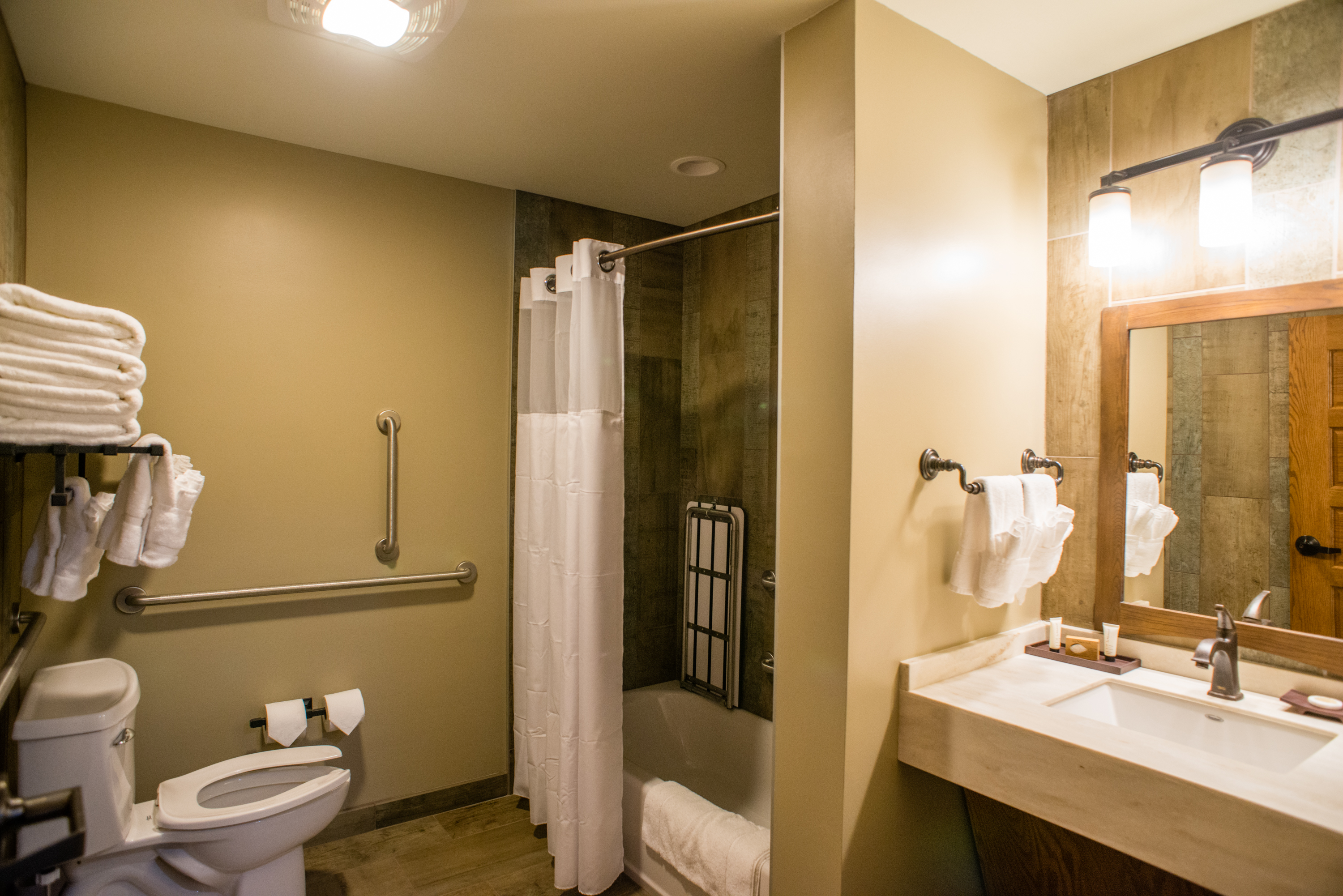 a full bathroom with a toilet, shower, bath, and sink