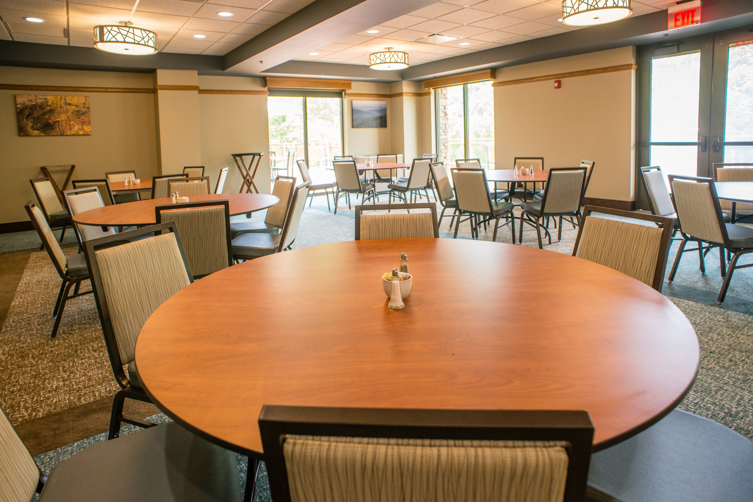 a large room with several round tables with chairs