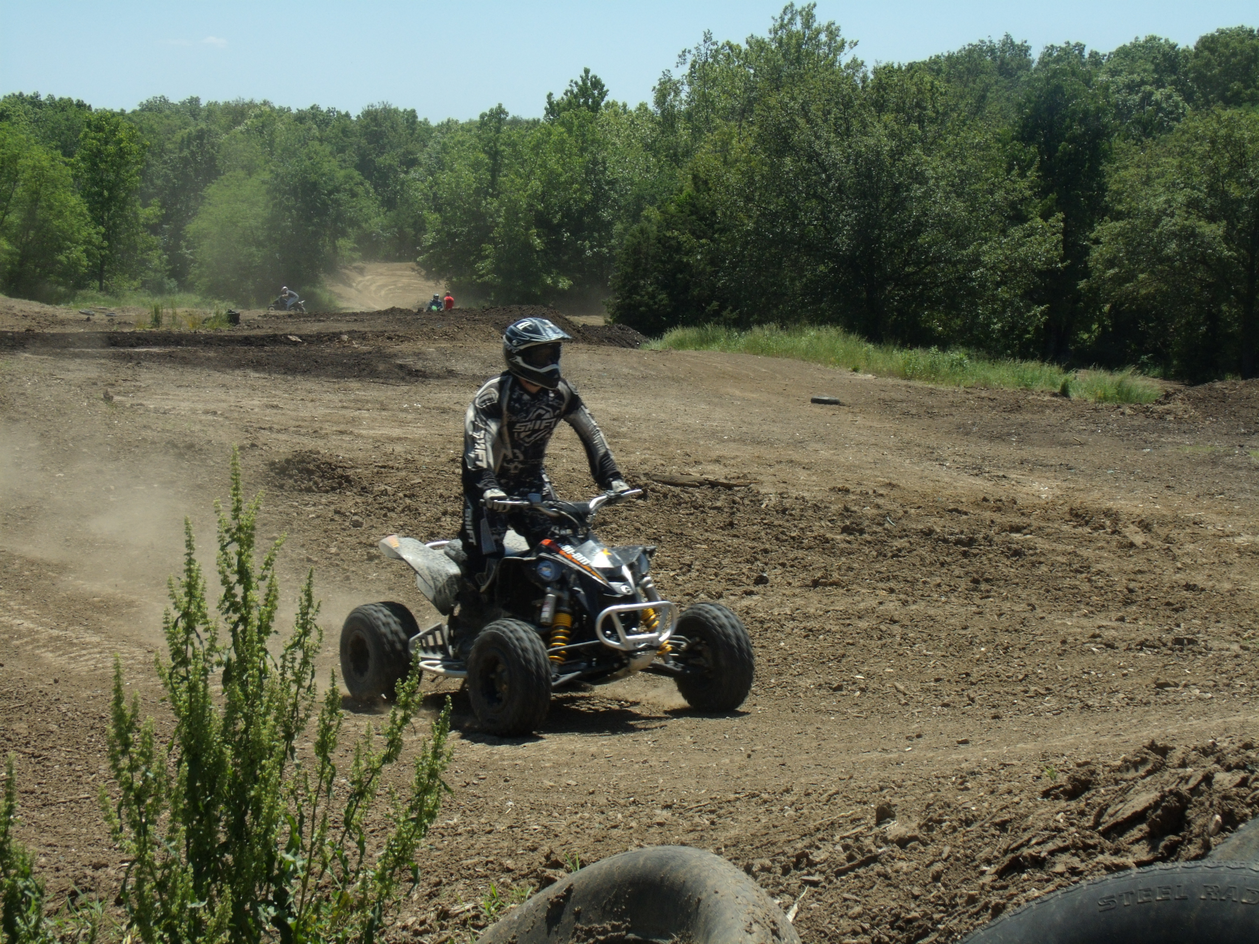 A person riding an ATV on a dirt field