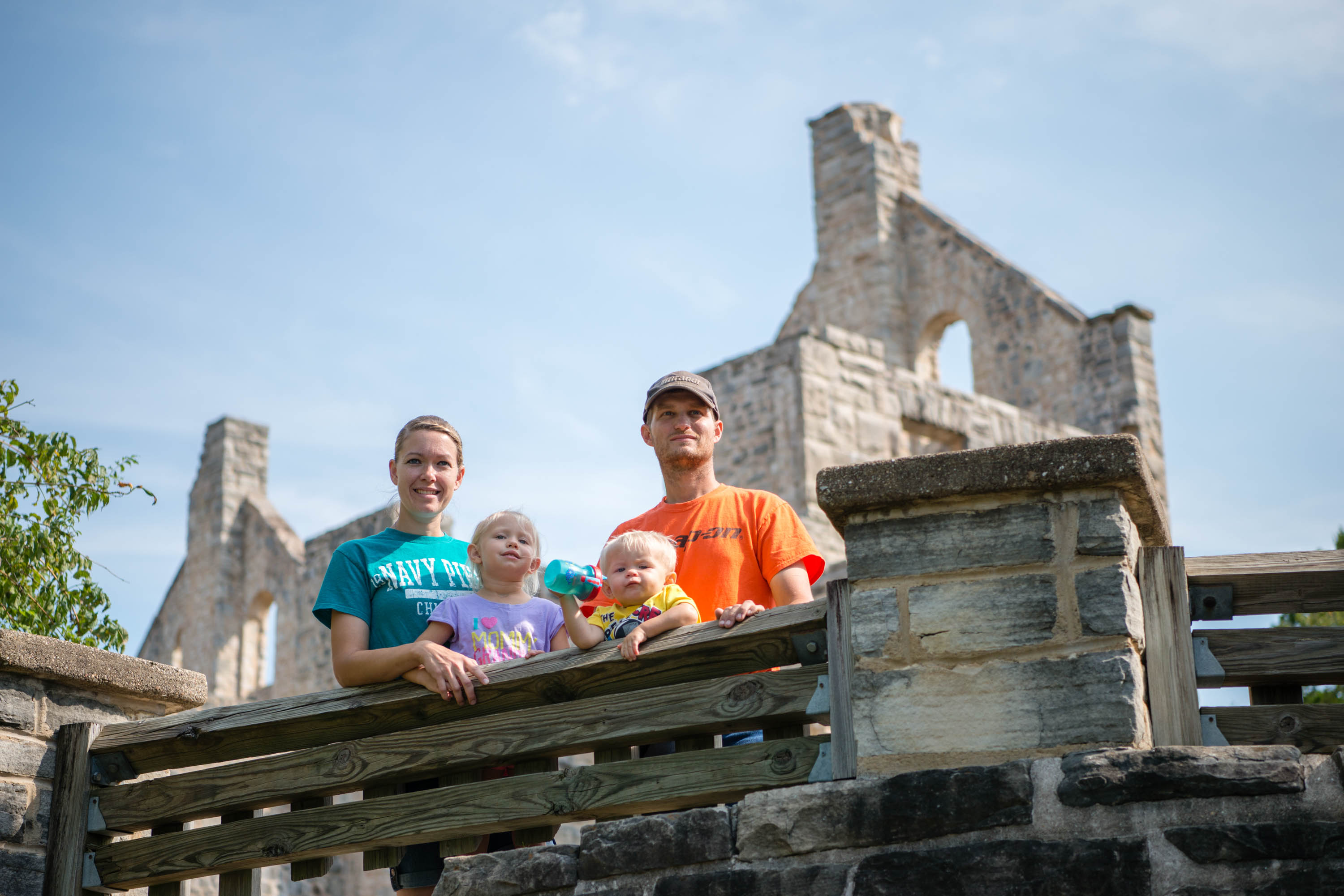 Family standing in front of ruins of a stone building