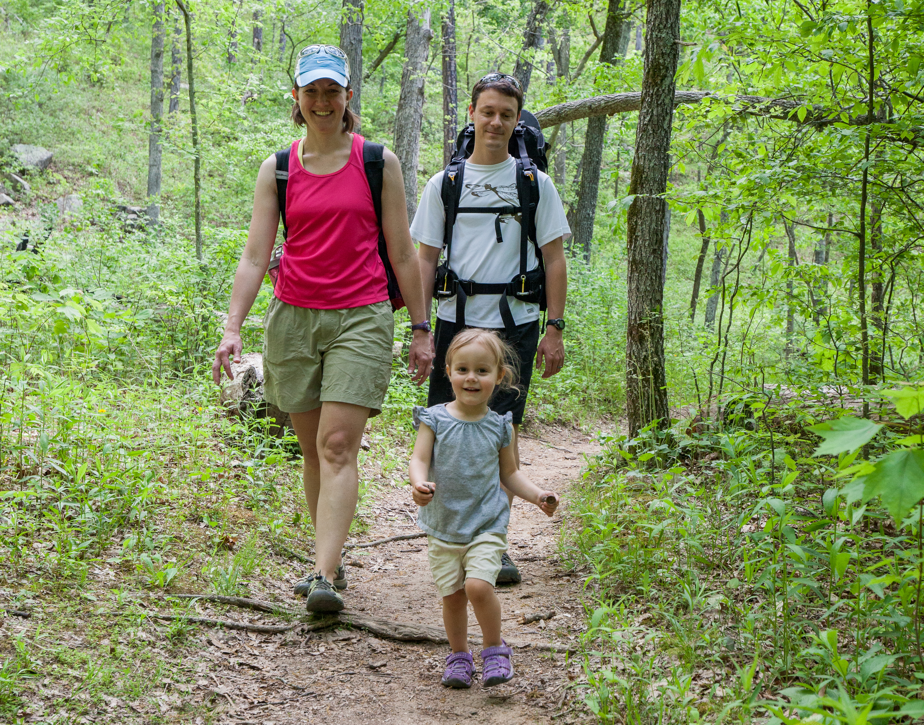 A family hiking a wooded trail