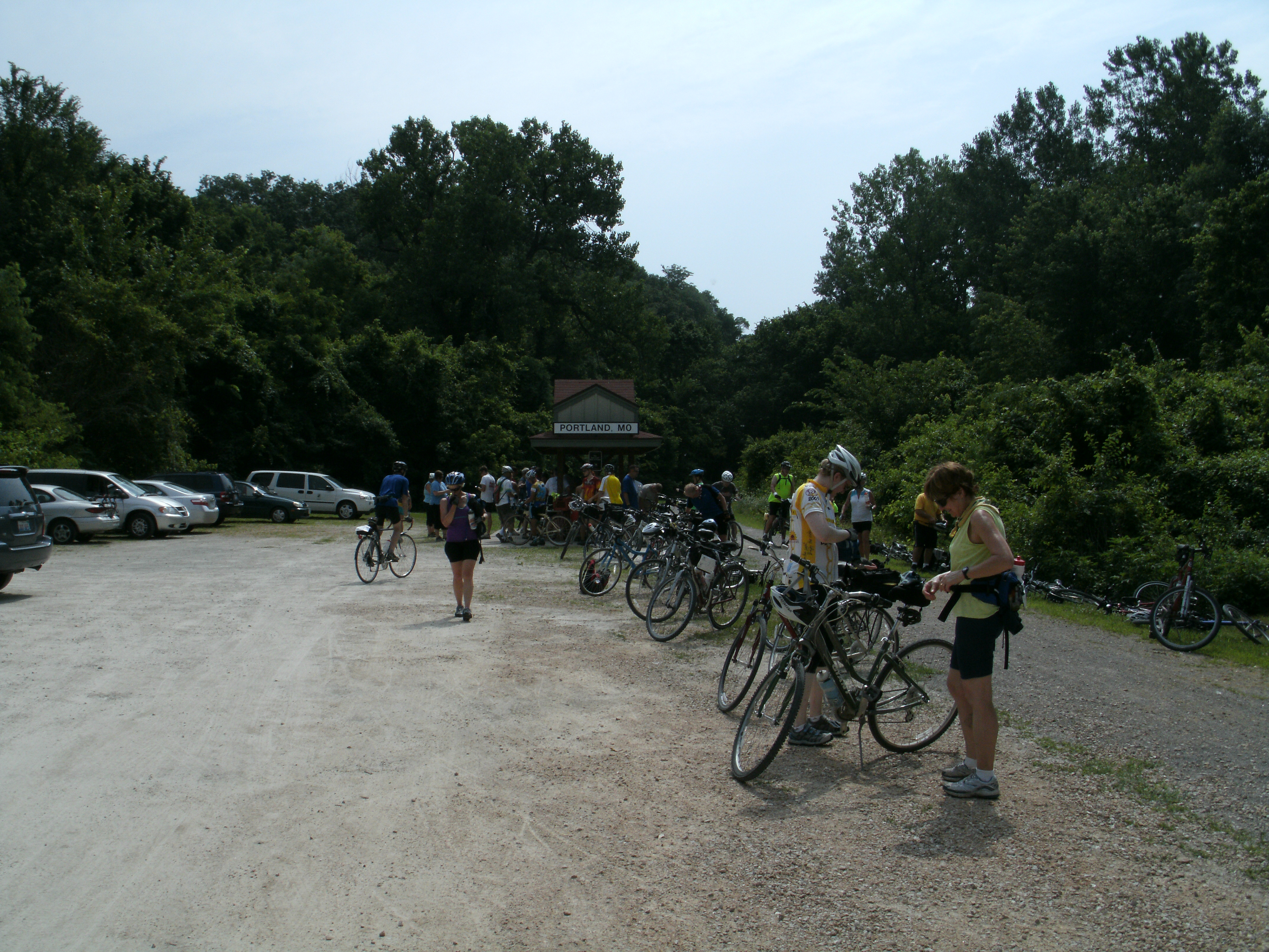 People gathered around their bikes on a trail