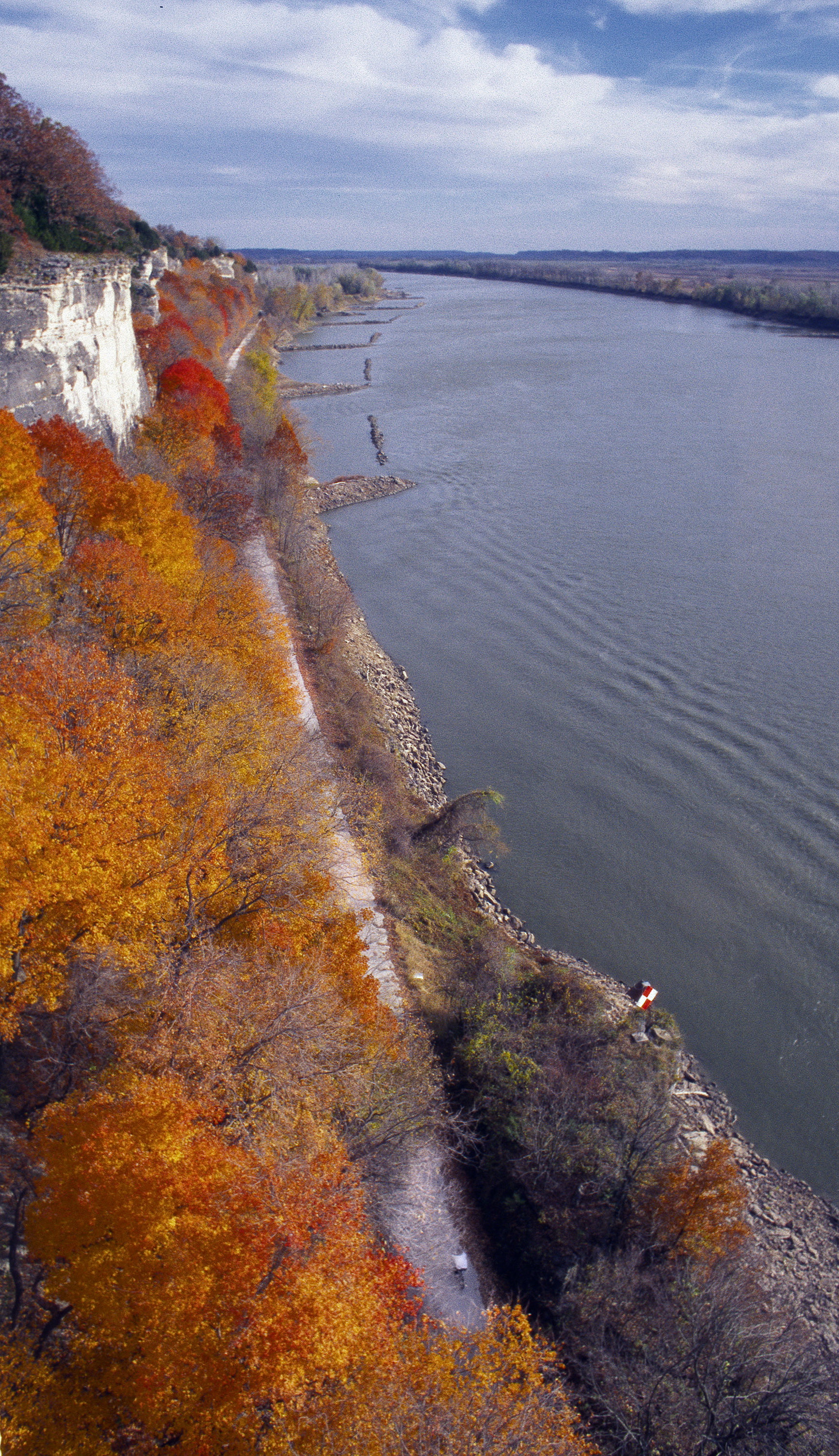 Aerial view of a person biking on a cliffside trail