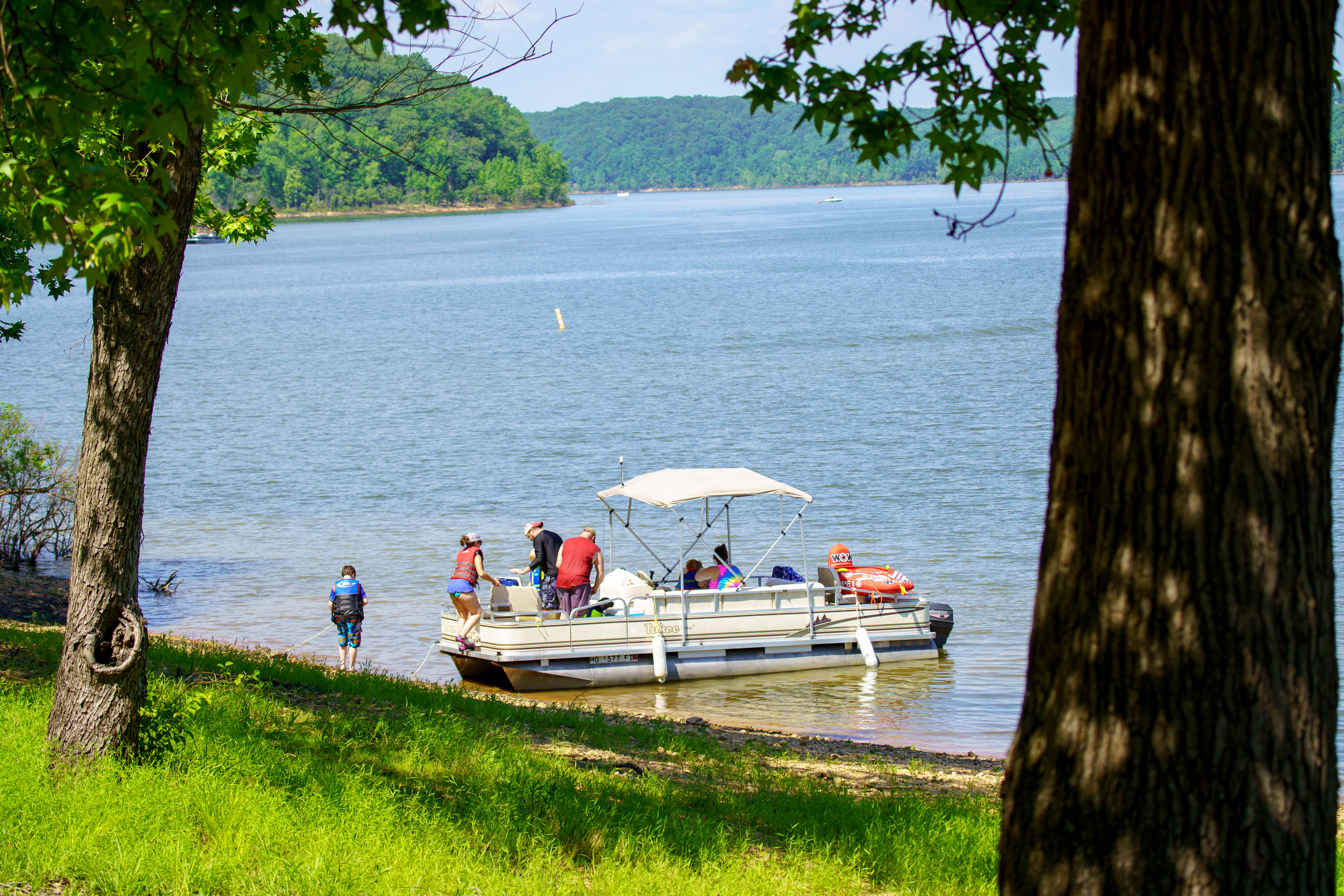 People gathered on a boat by the shore
