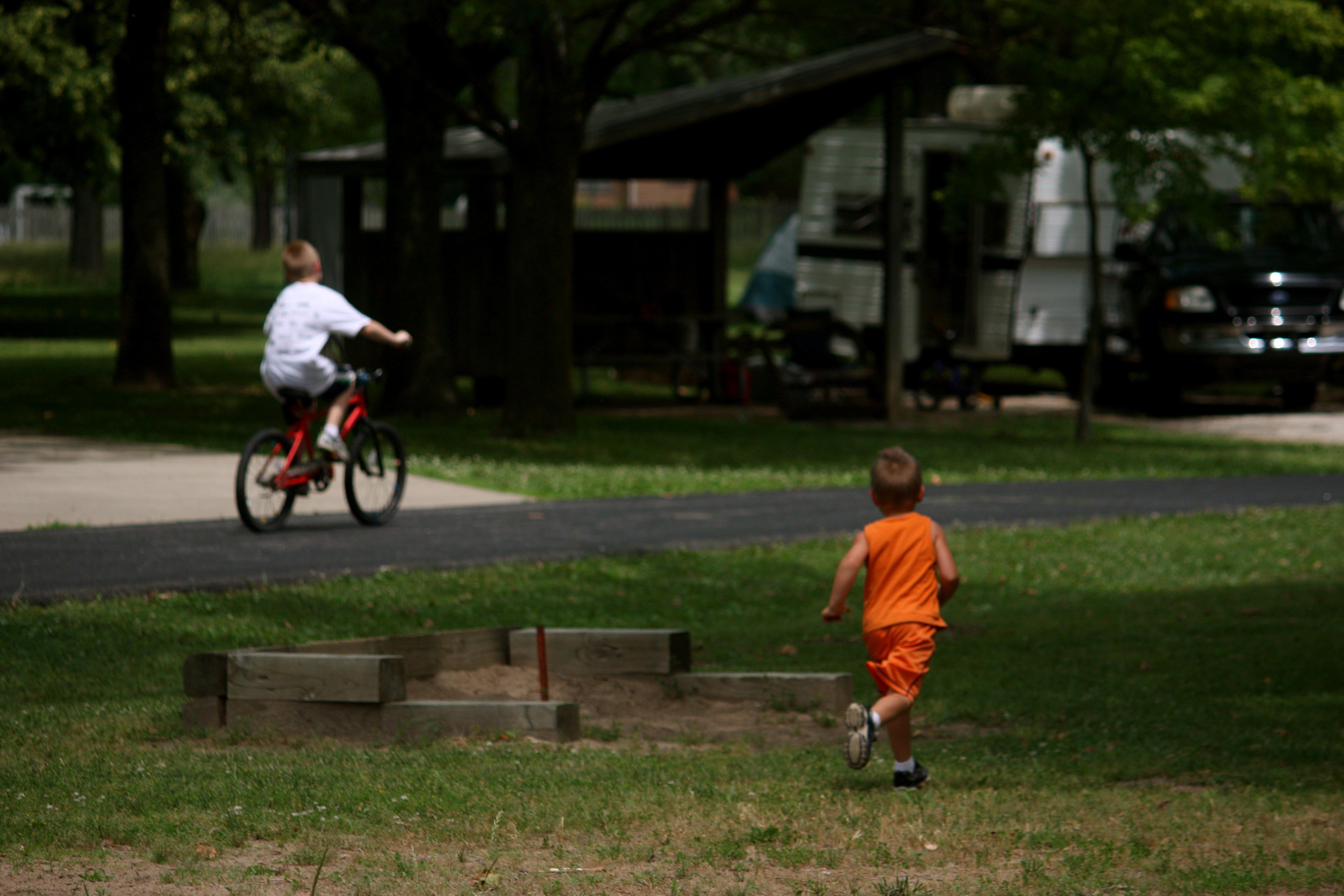Two kids playing in a campground