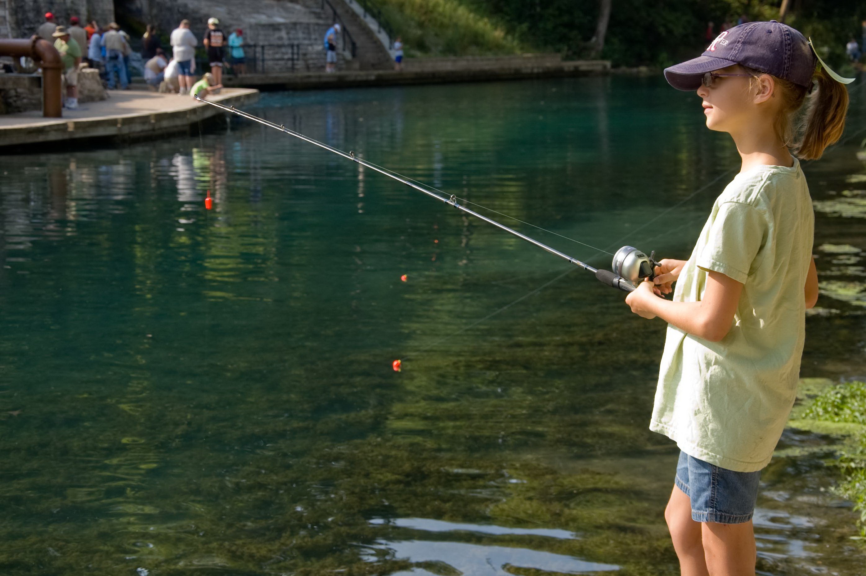a girl fishing at a river