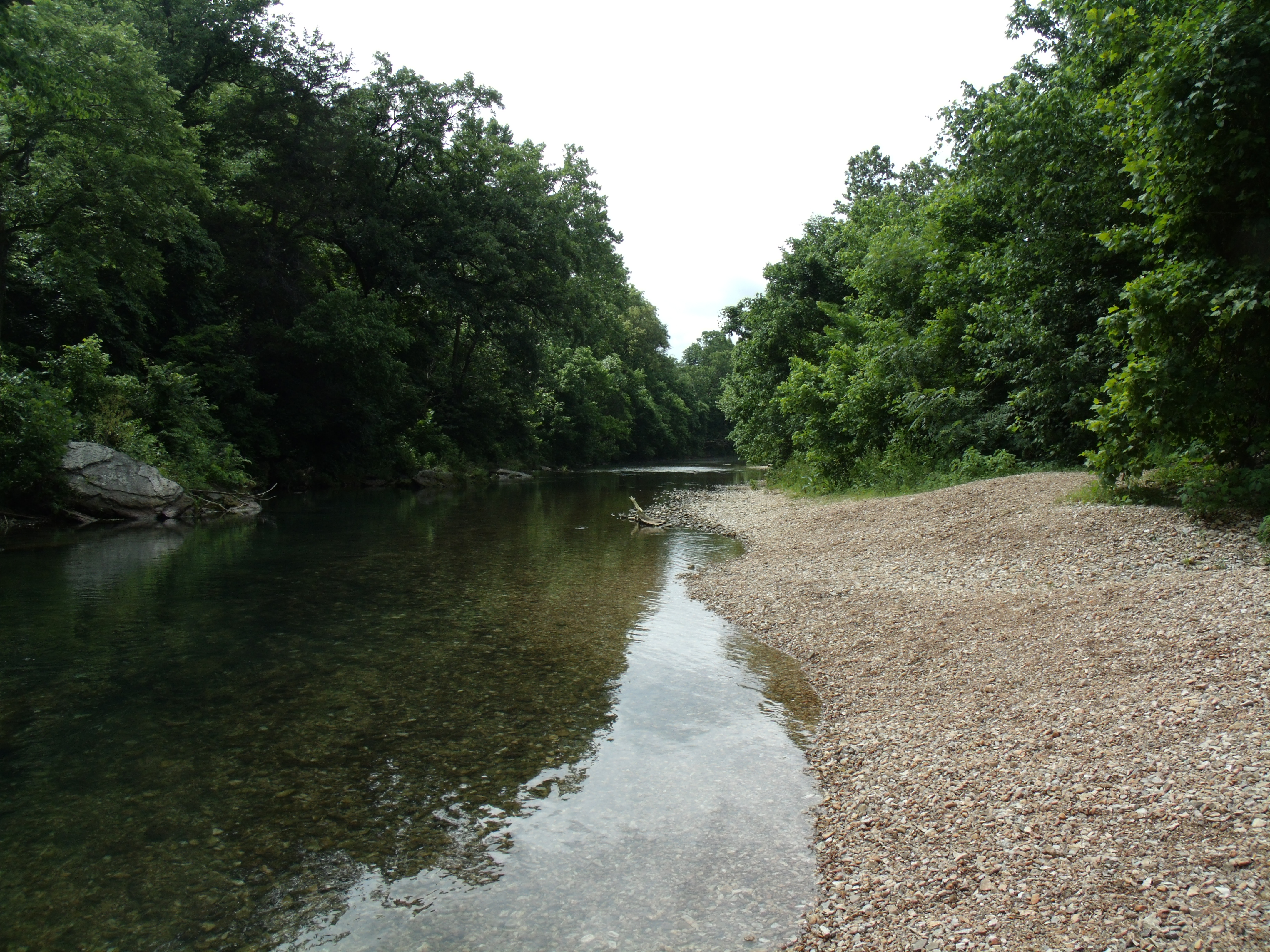 a river with a rocky shore