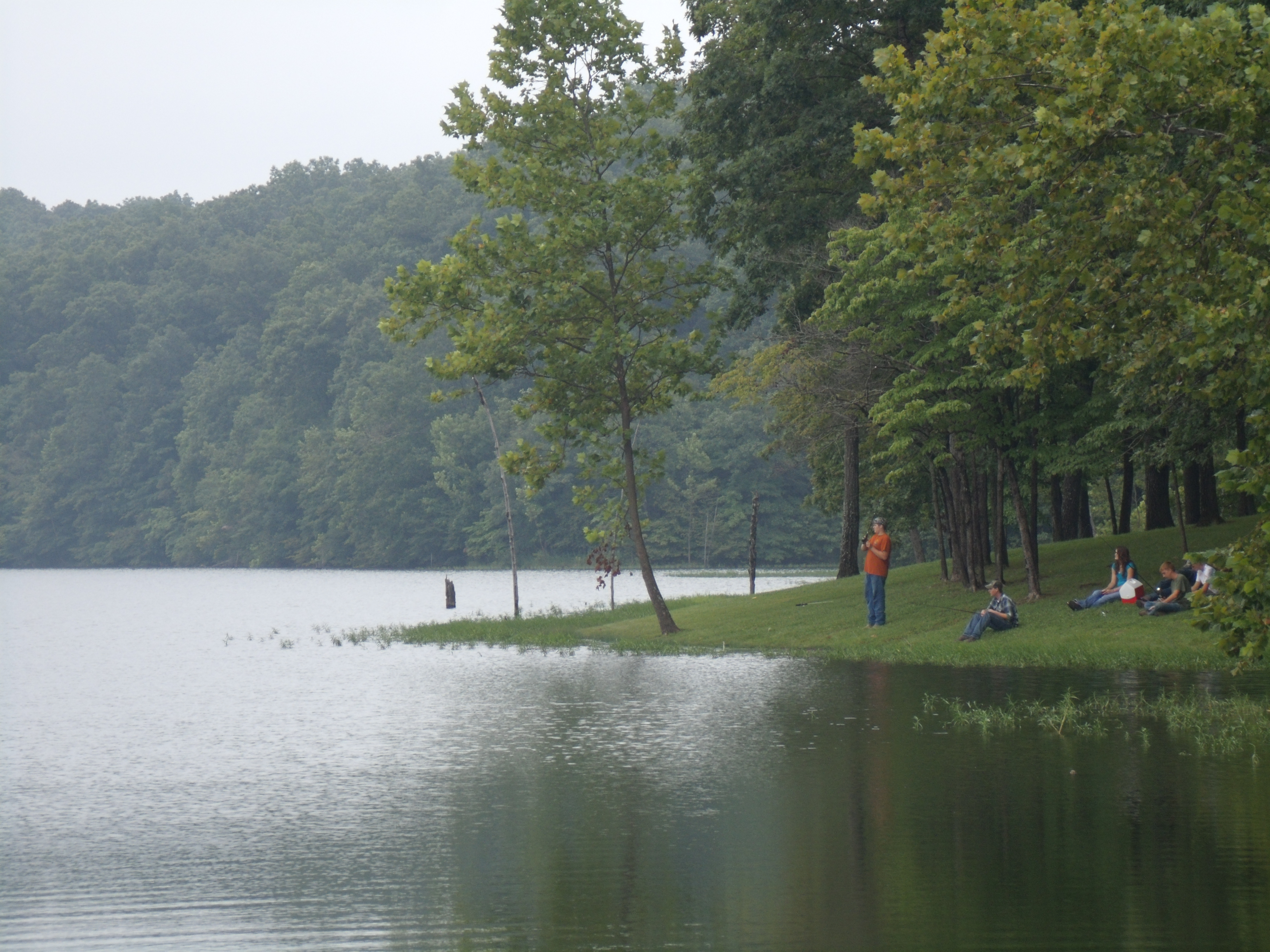 A group of people fishing on a lake.