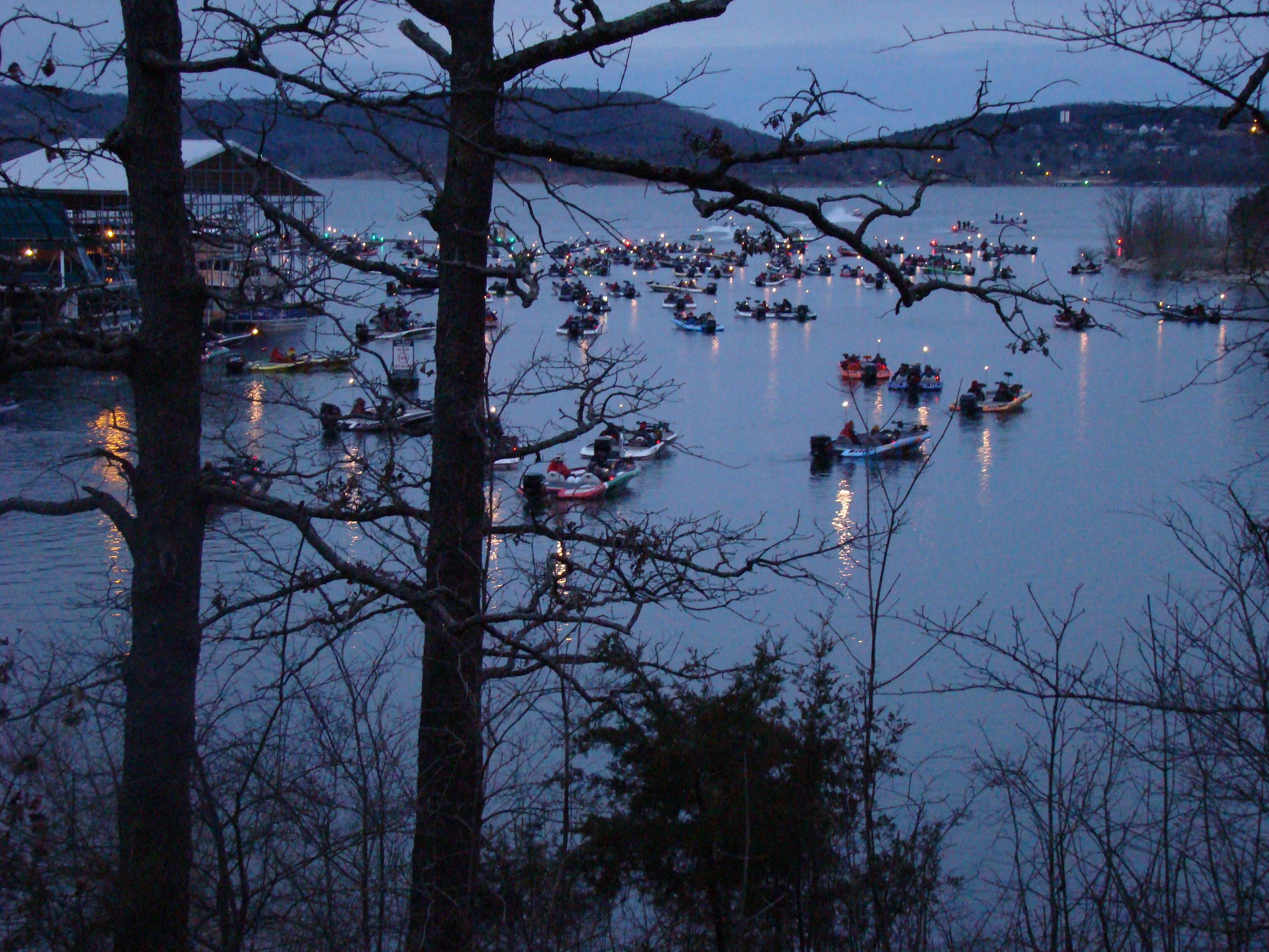 Boats on a lake with torches at night