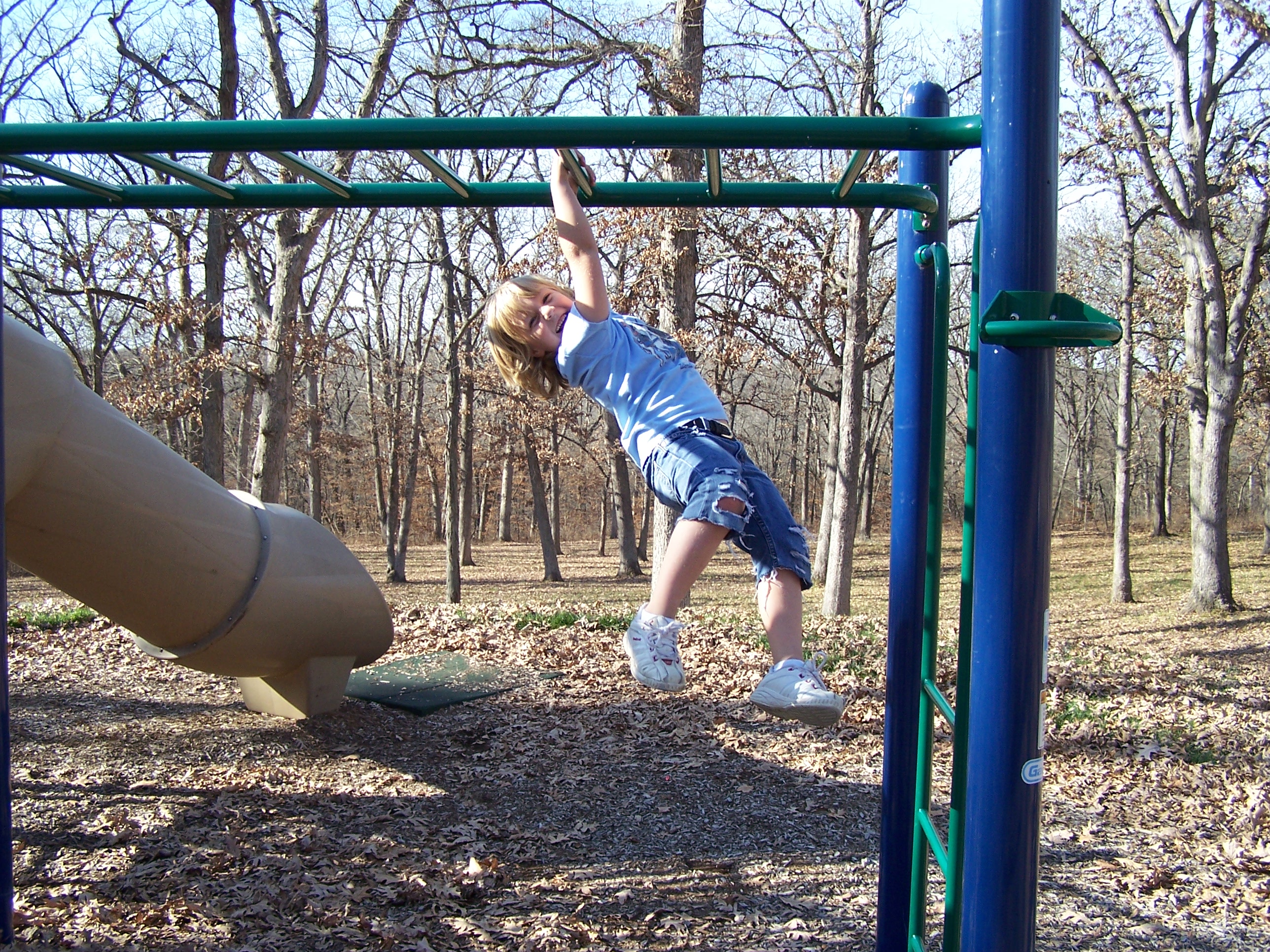A kid playing on monkey bars