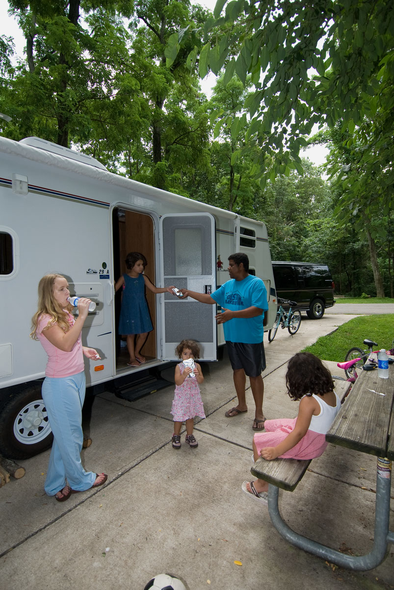 A family outside a camper