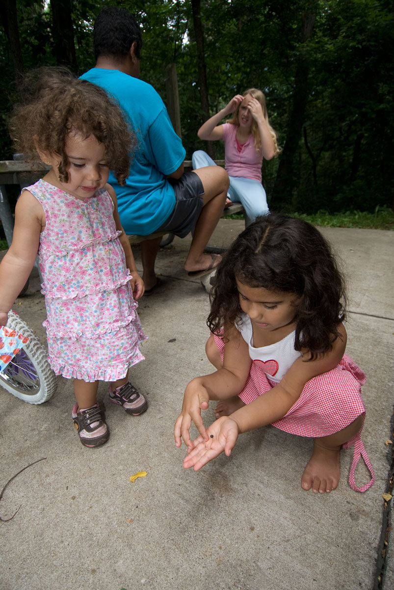 A little girl playing with a roly-poly