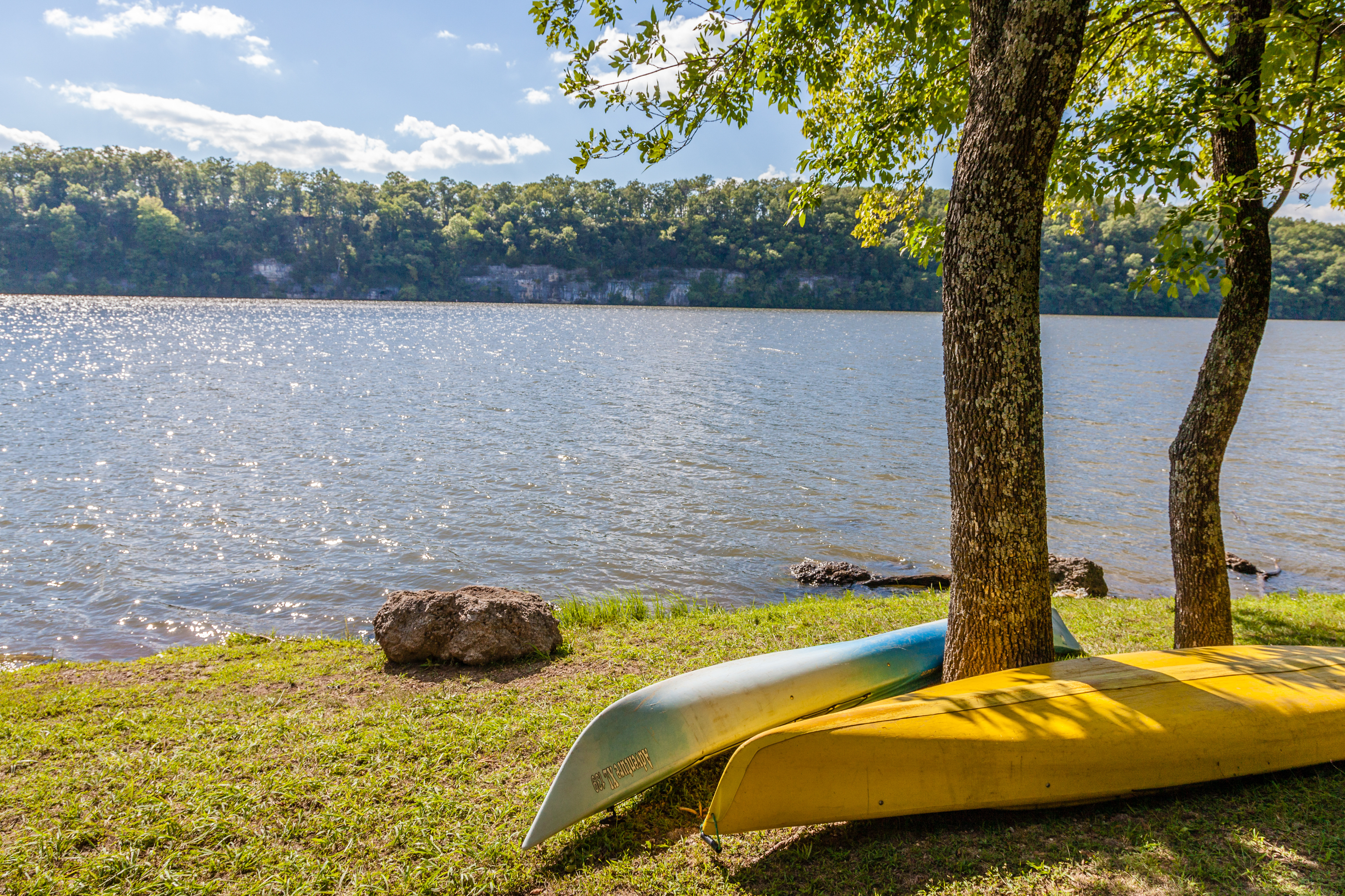 Kayaks sitting on a hill overlooking the lake