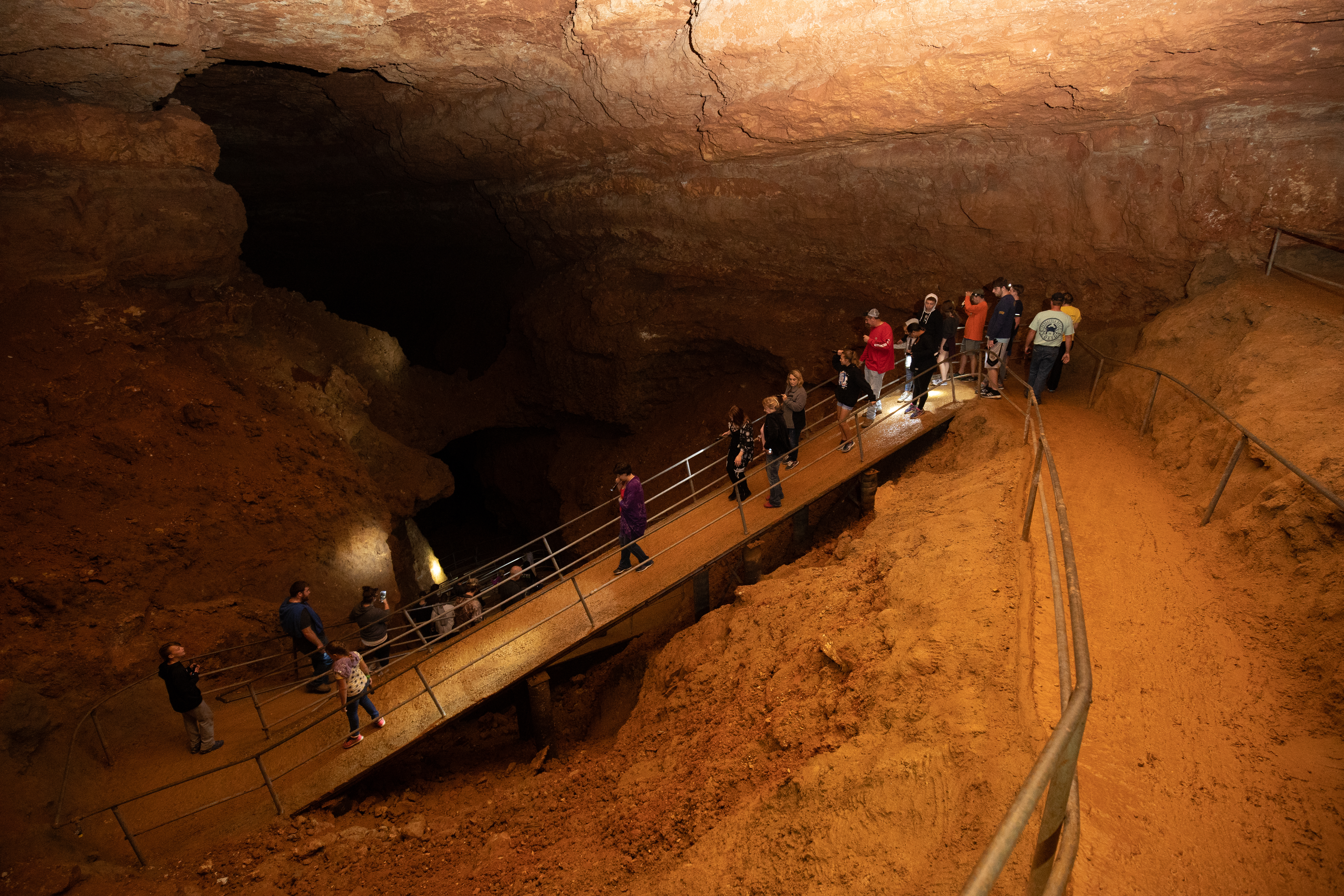 People descending a ramp into a cave