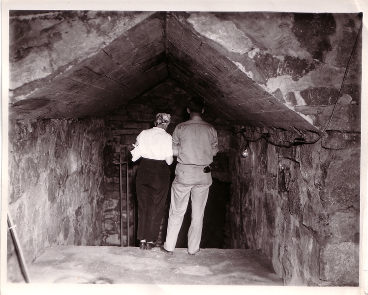Two people standing in a cave