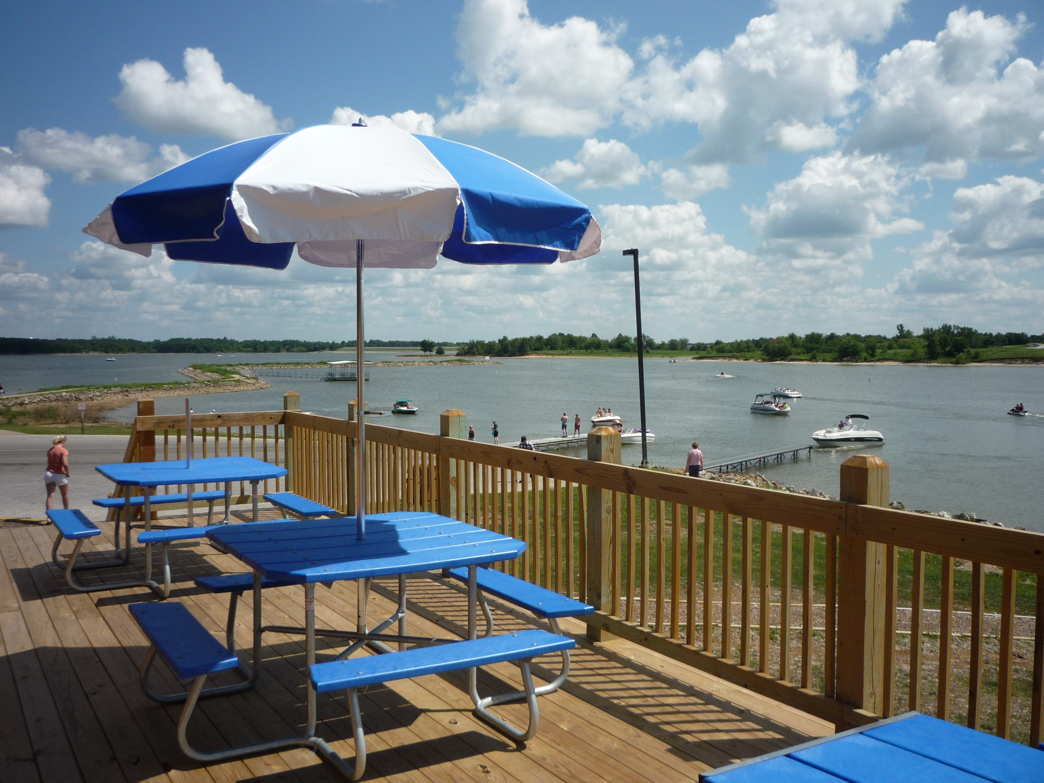 Blue tables on a balcony overlooking the water