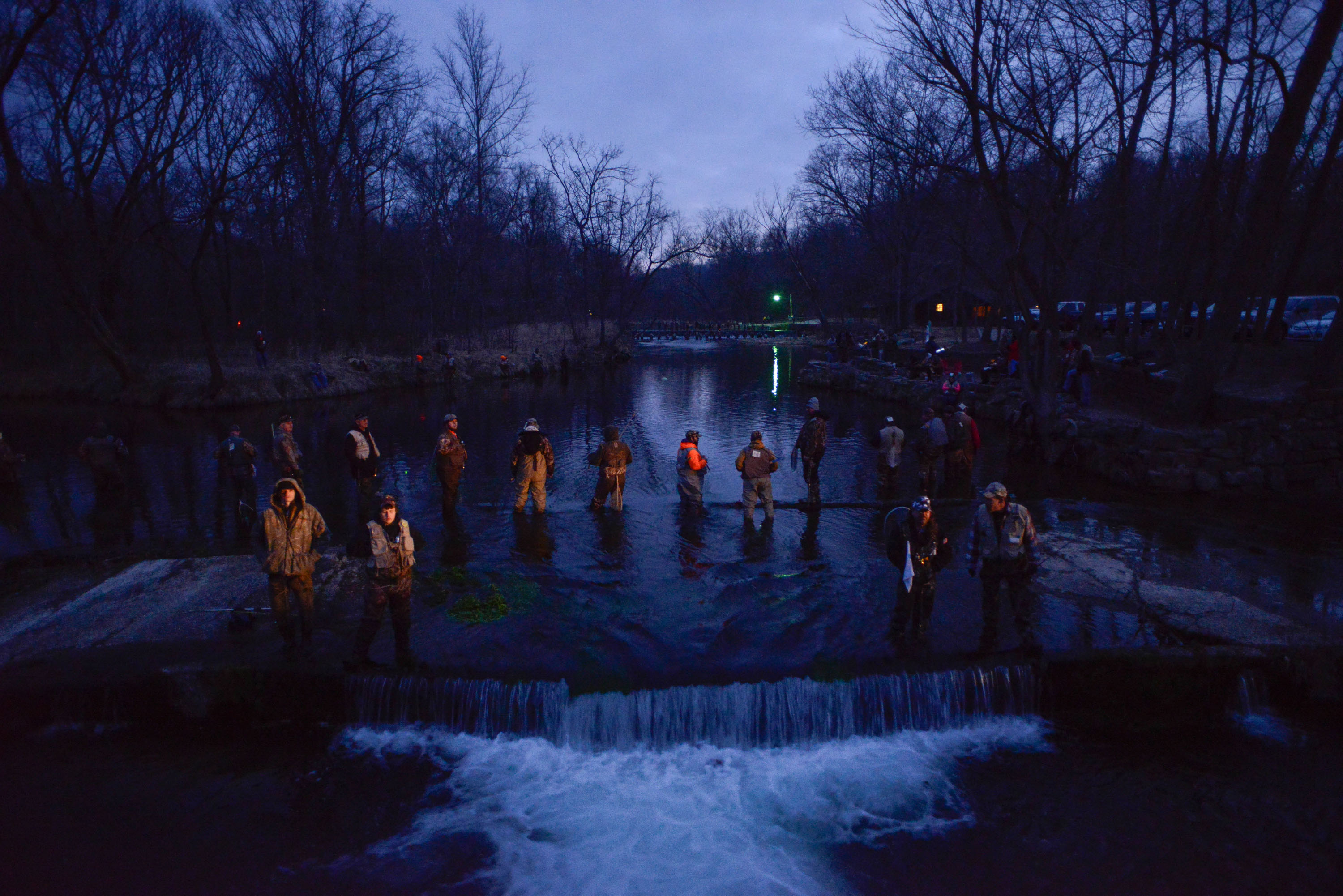 A group of people fishing at night