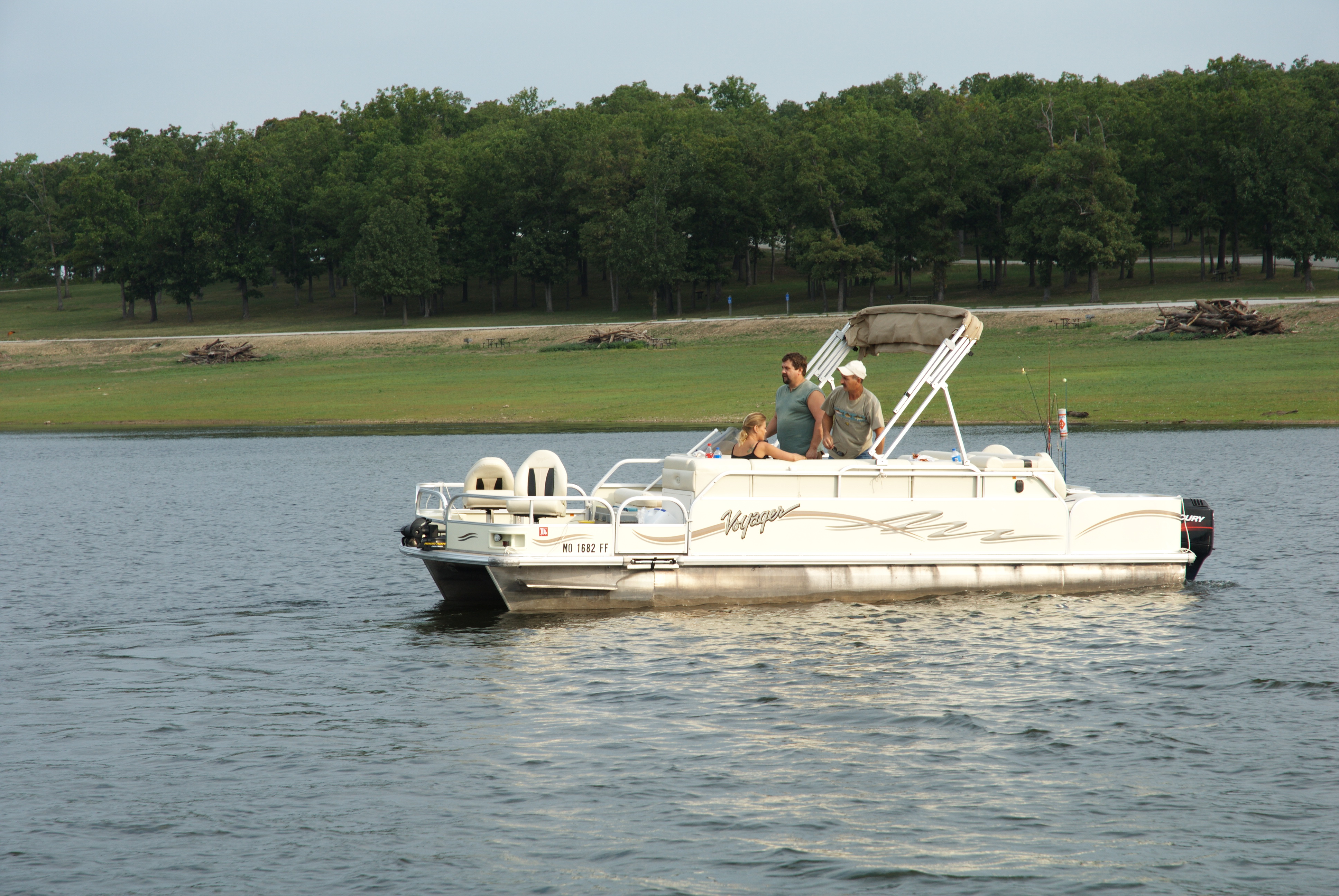 Three people in a boat on a lake