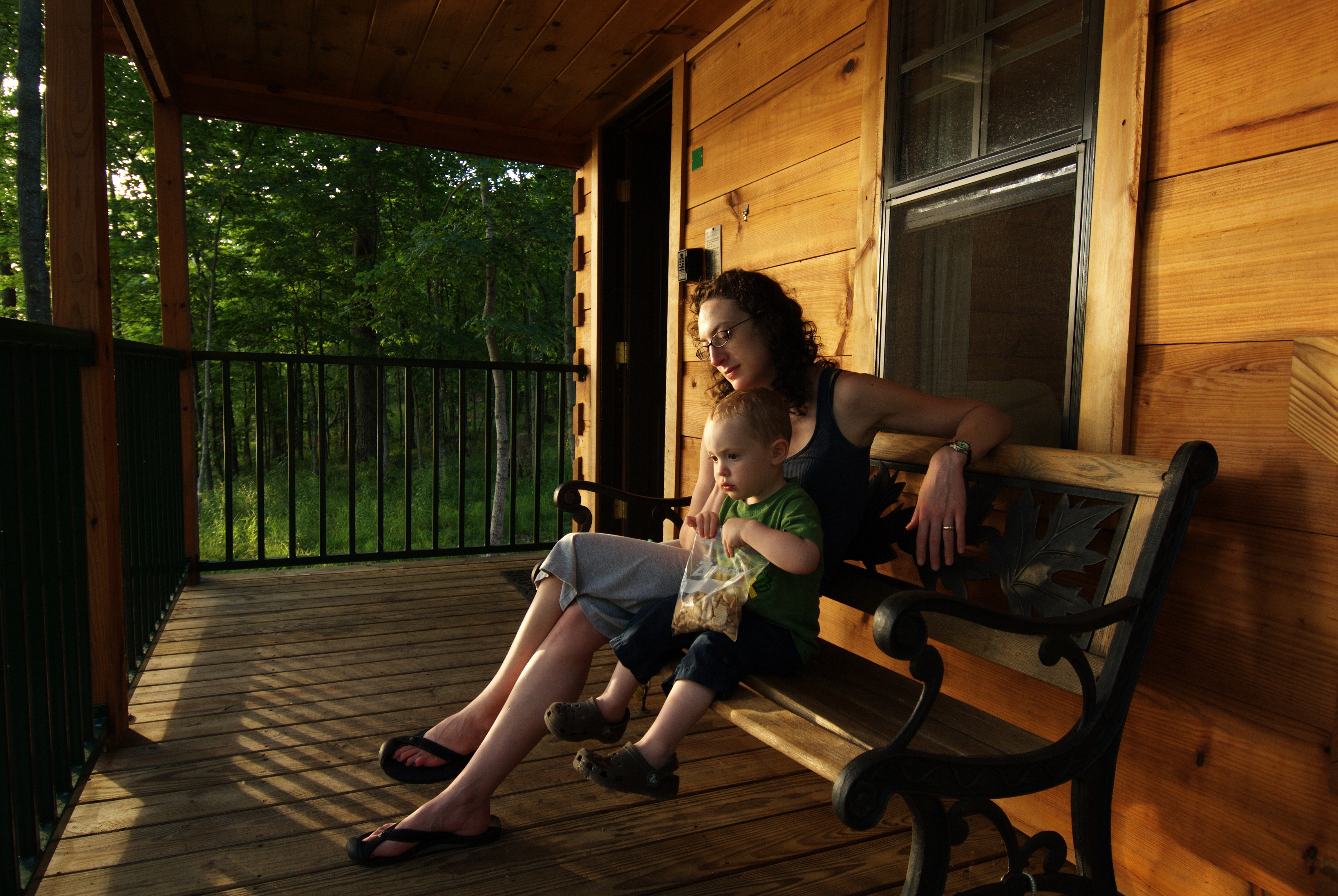 A person sitting on a bench with a child