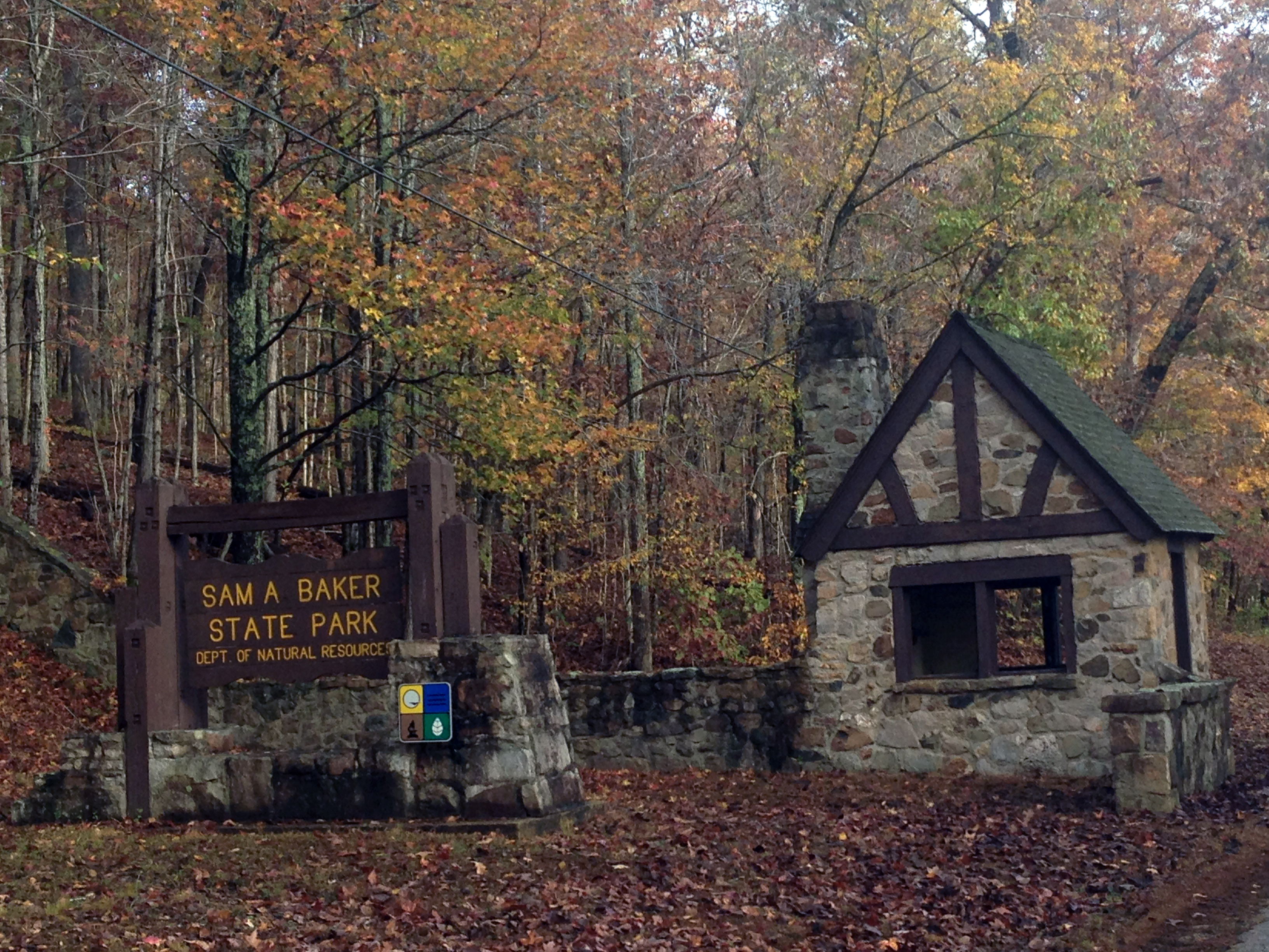 Sam A. Baker gate entrance with park sign and rock structure.