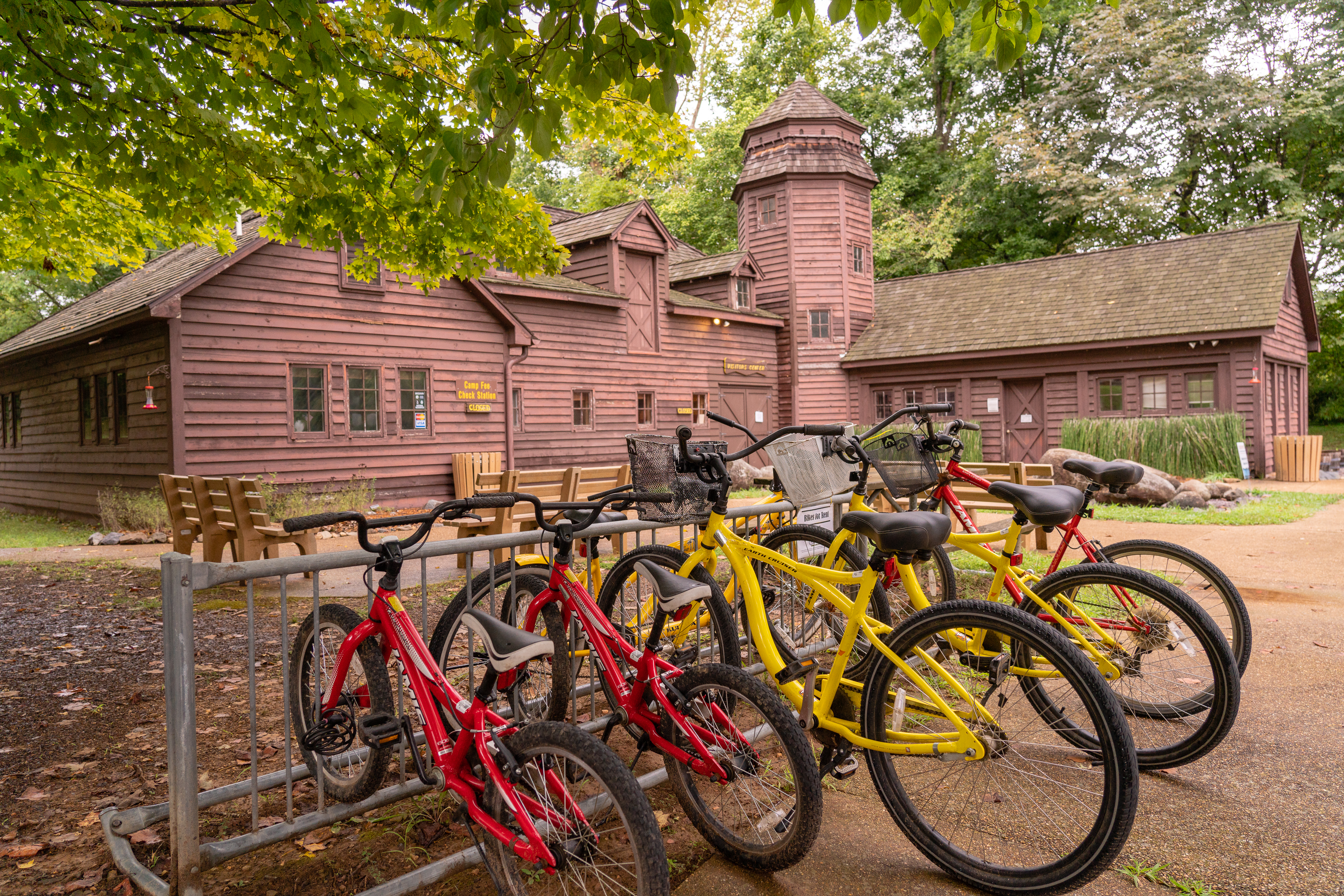 Visitor center building with red and yellow bicycles out front in bike rack.