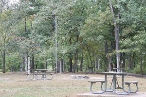 two picnic tables and a fire ring